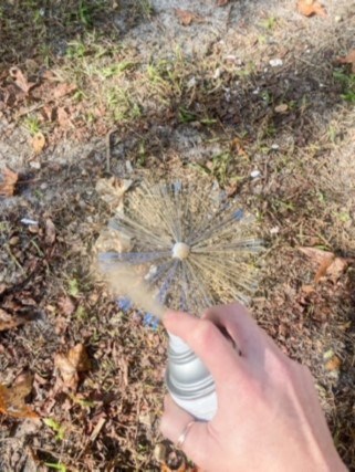 Spray painting ball with broom bristles