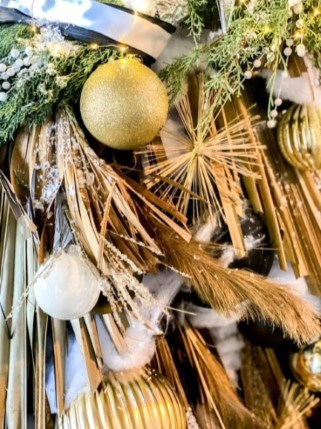 painted ball with bristles among other Christmas decorations